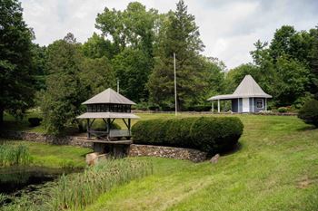 a gazebo and a pavilion in a park next to a river at Woodbury, Woodbury, 06798